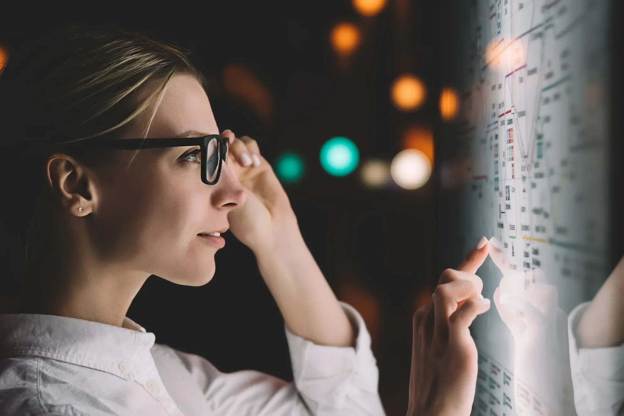 A person interacting with a transparent digital display